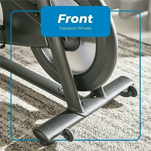 Exercise bike front transport wheels on carpet.