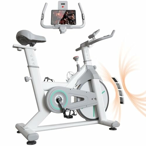 Modern stationary exercise bike with digital display and tablet holder.