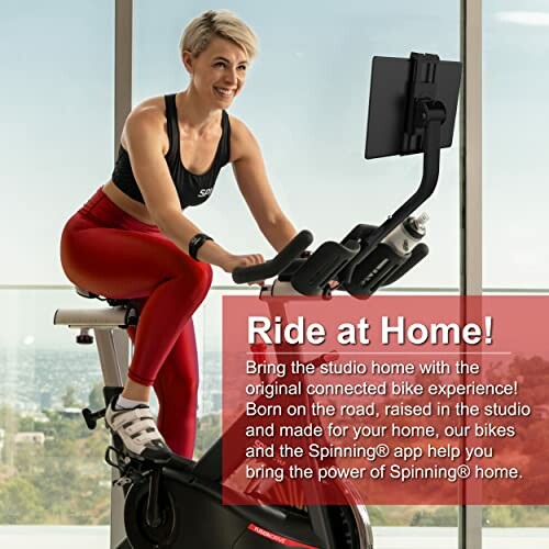 Woman using a stationary exercise bike at home